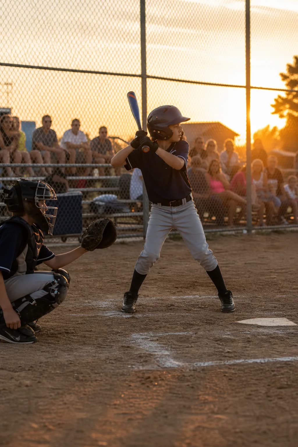 Youth baseball game at sunset